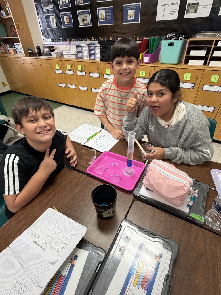 Kids posing during a science lesson.