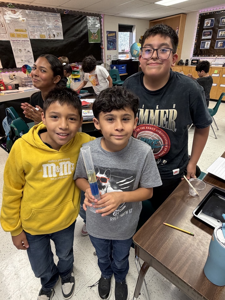 Kids posing during a science lesson.
