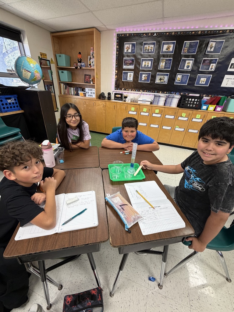 Kids posing during a science lesson.
