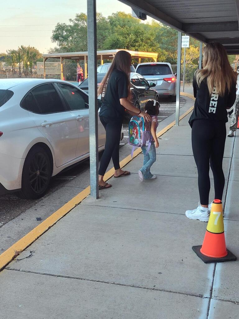 Volleyball player walking with student.