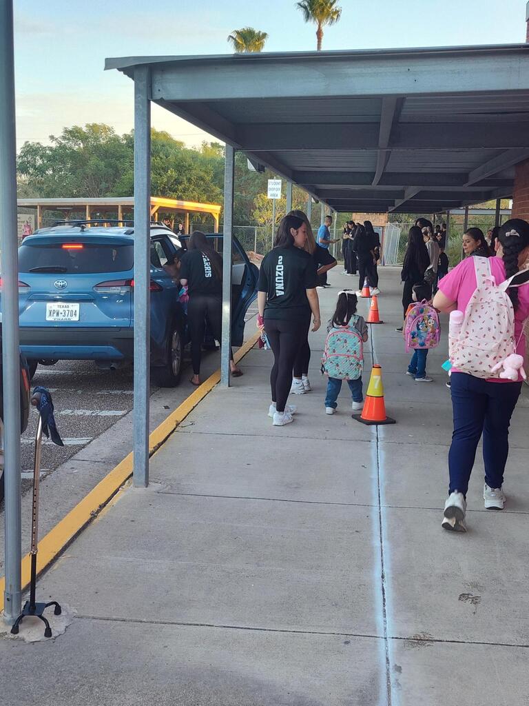 Volleyball player walking with student.