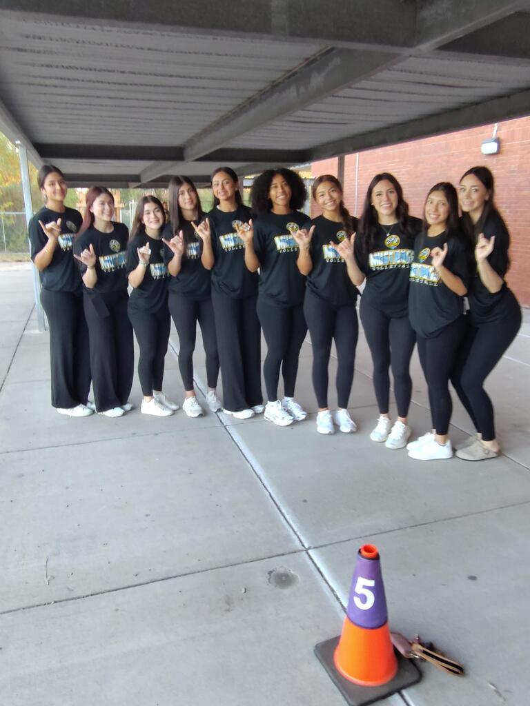 Volleyball players posing for picture.