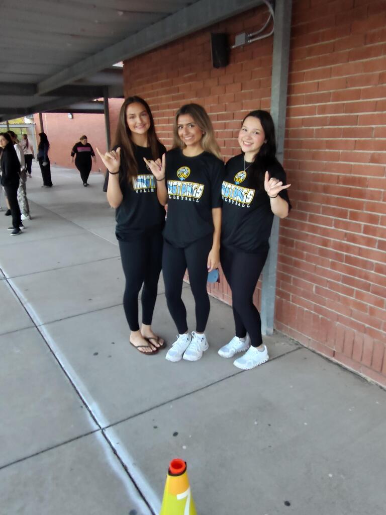 Volleyball players posing for picture.