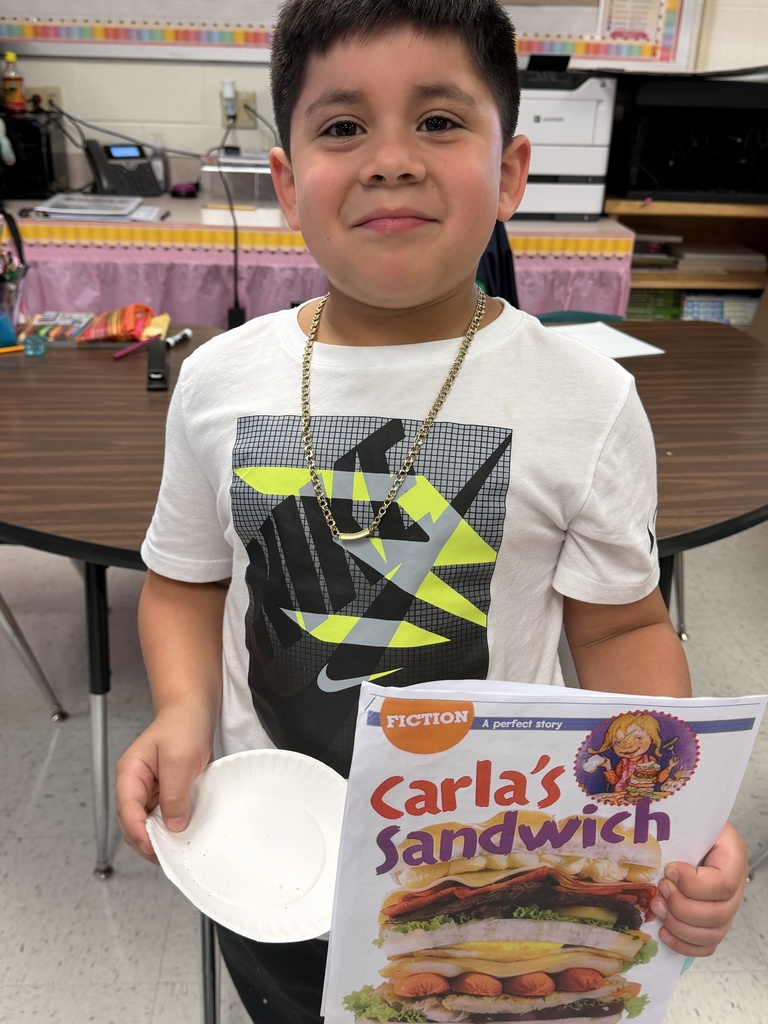Student posing with book cover.