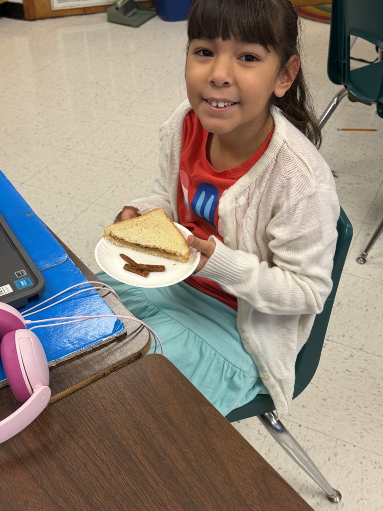 Student posing with sandwich.