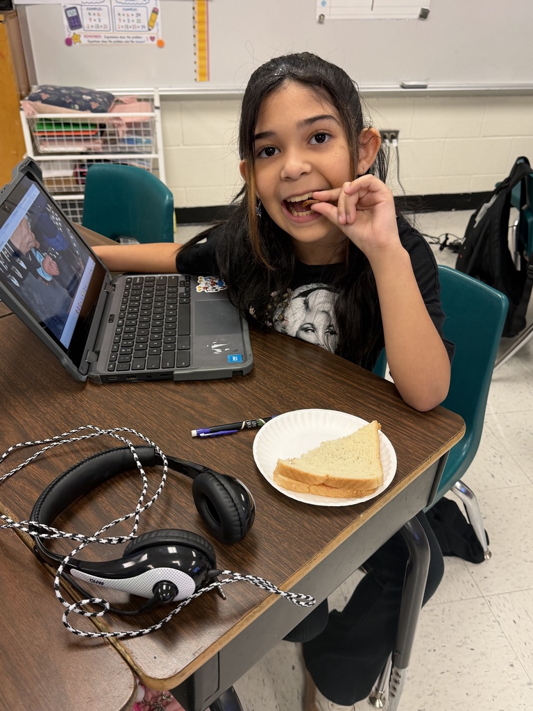 Student posing with sandwich.