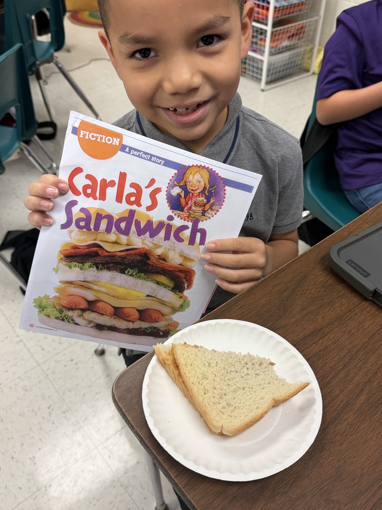 Student posing with sandwich.