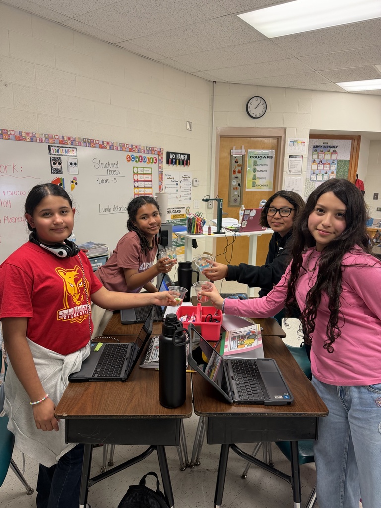Students posing for science activity.