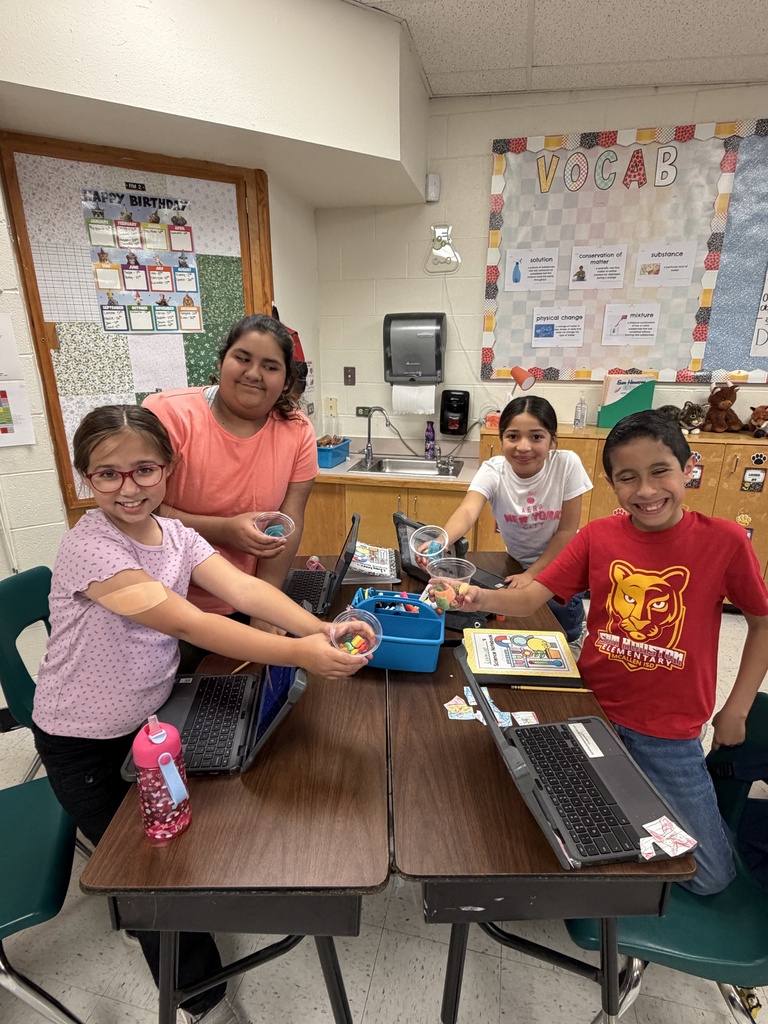 Students posing for science activity.