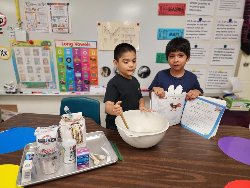 Students posing for making cookies learning activity.
