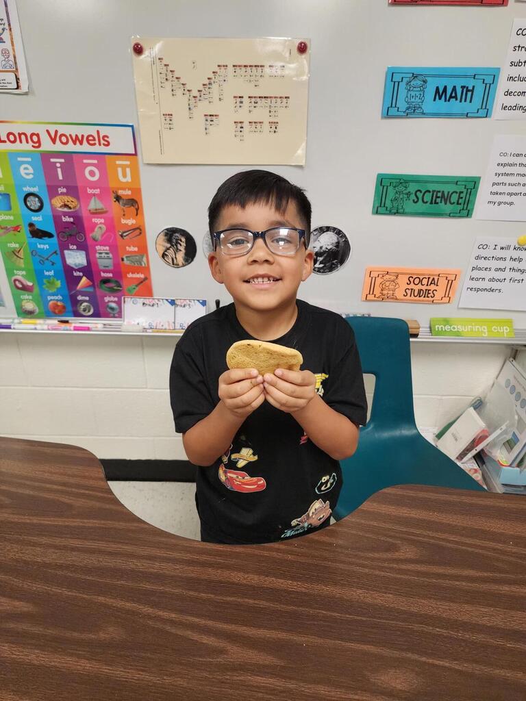 Students posing for making cookies learning activity.