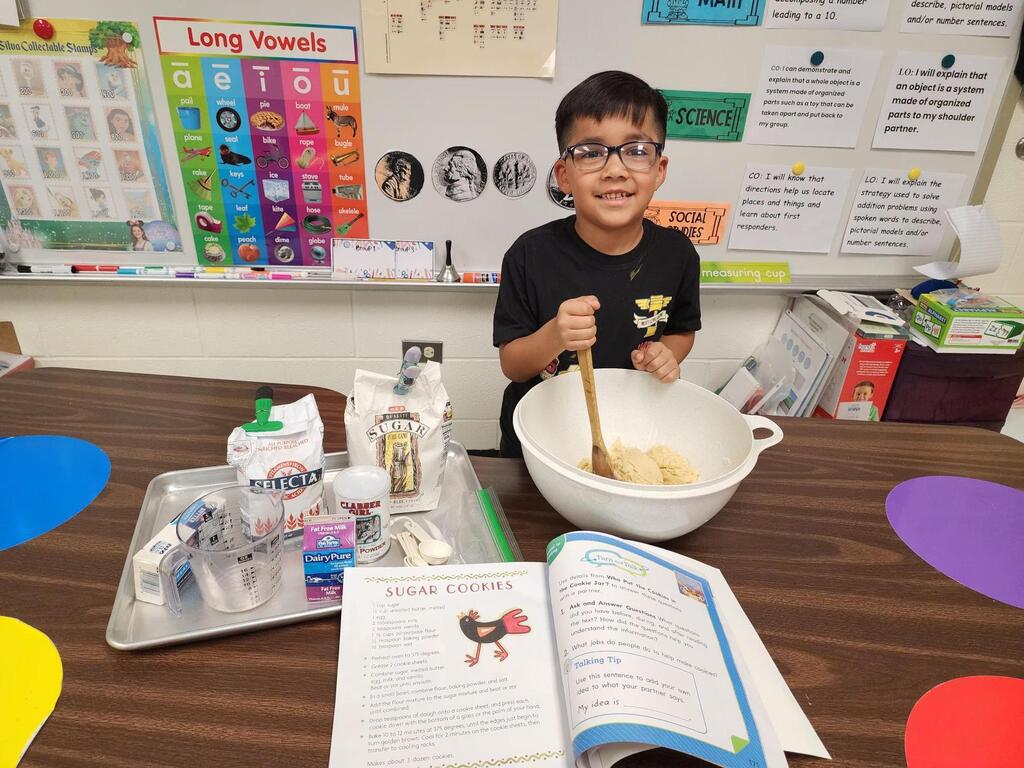 Students posing for making cookies learning activity.