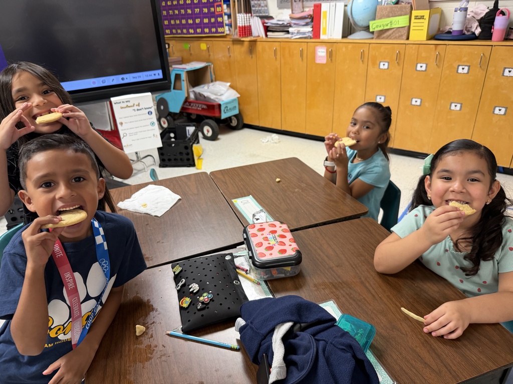 Students posing for making cookies learning activity.