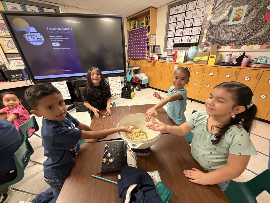 Students posing for making cookies learning activity.