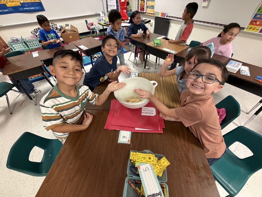 Students posing for making cookies learning activity.