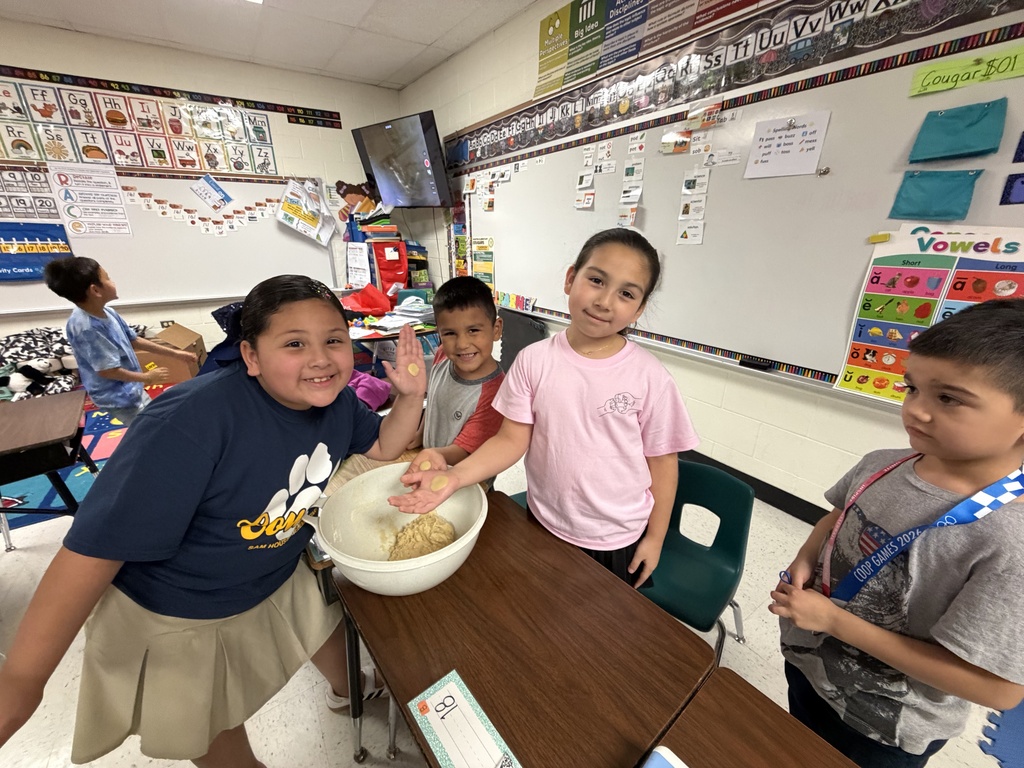 Students posing for making cookies learning activity.