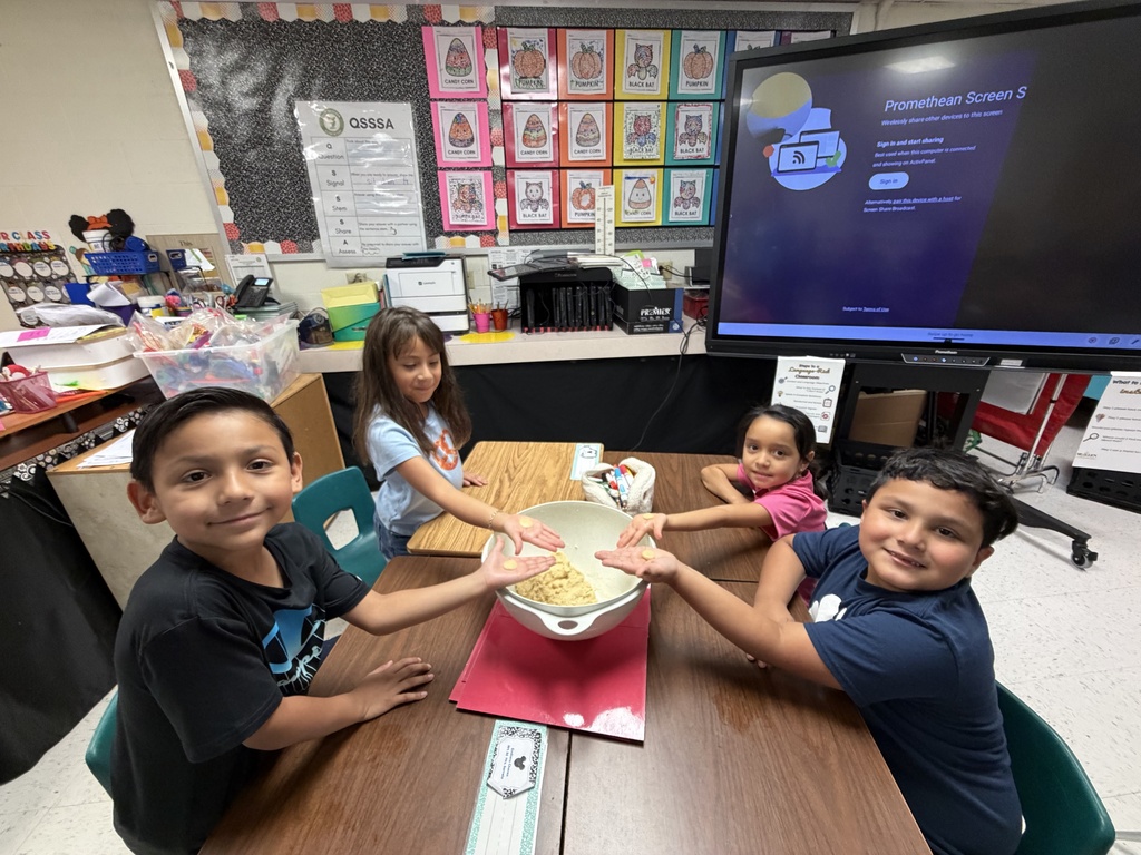 Students posing for making cookies learning activity.