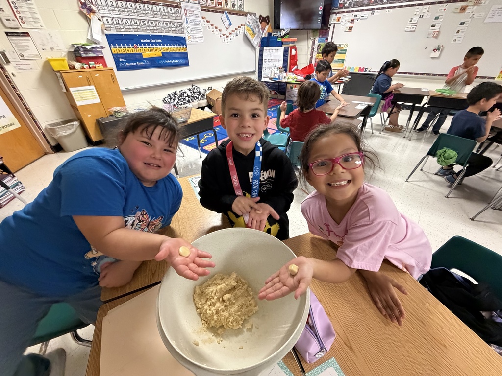 Students posing for making cookies learning activity.