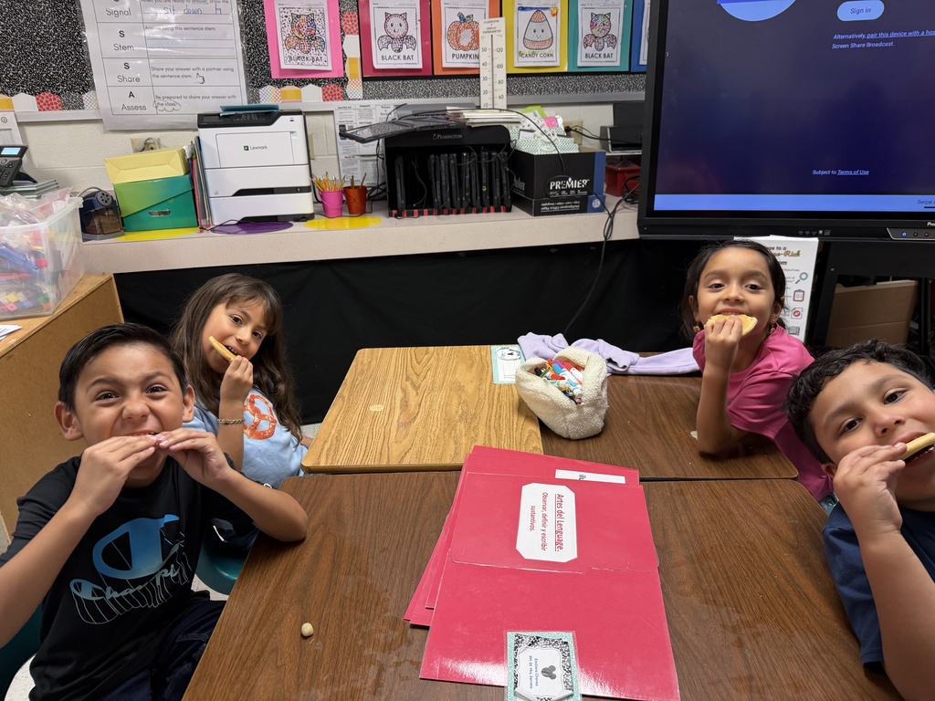 Students posing for making cookies learning activity.