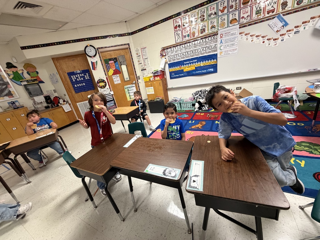 Students posing for making cookies learning activity.