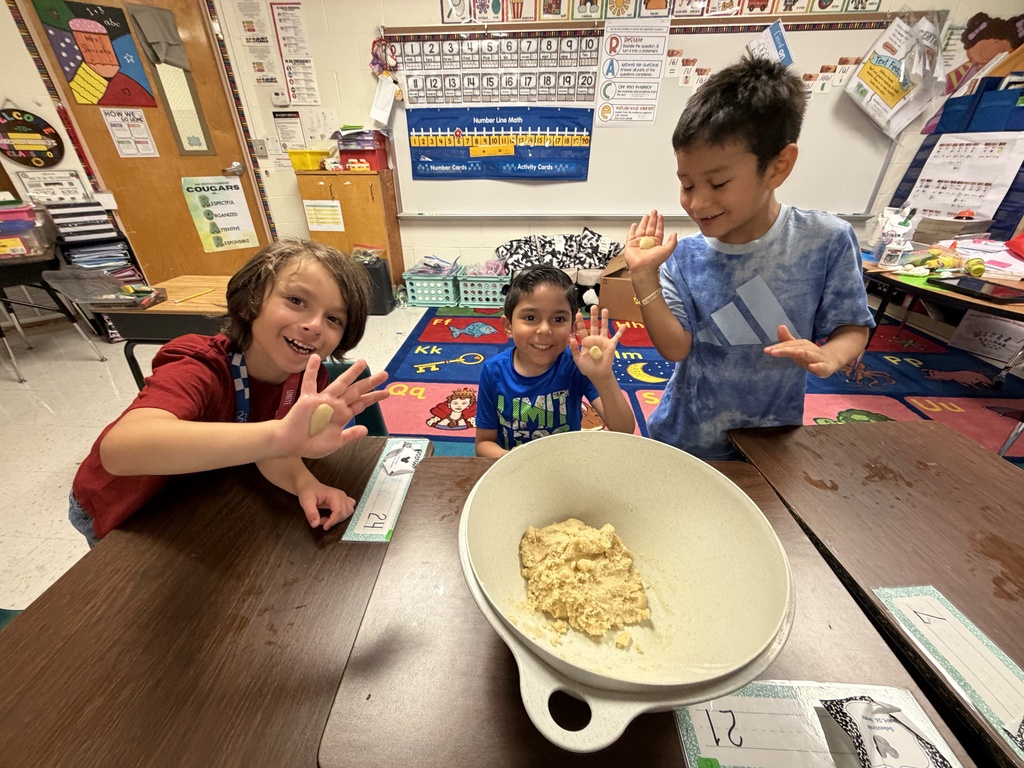 Students posing for making cookies learning activity.