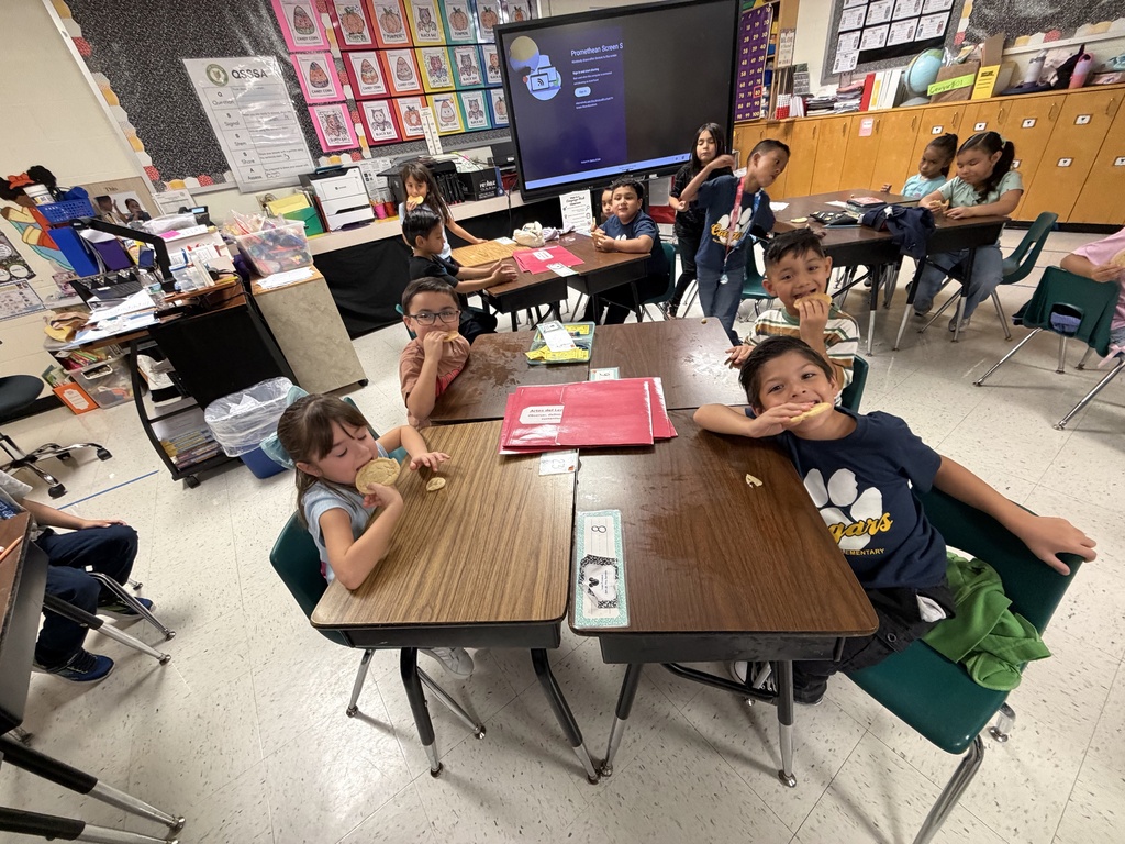 Students posing for making cookies learning activity.