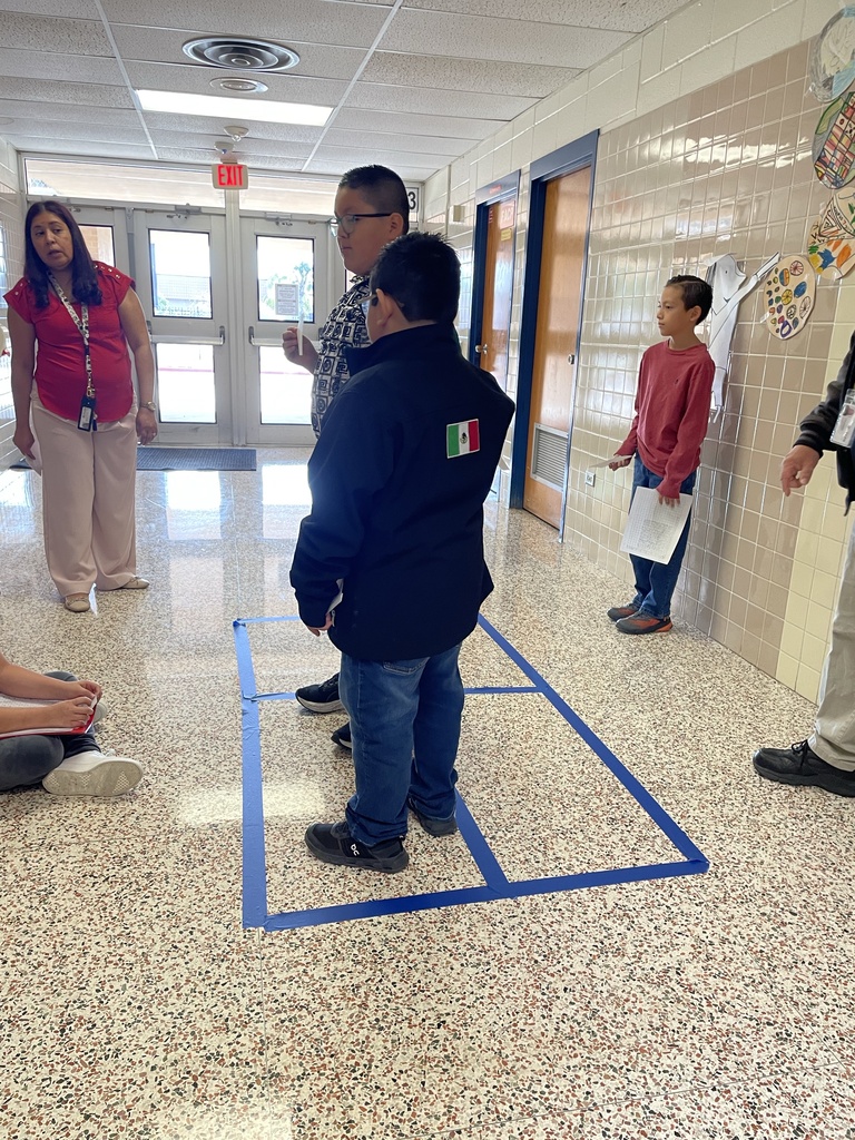 Students using total physical response to show multiplying 2 digits by 2 digits with area model