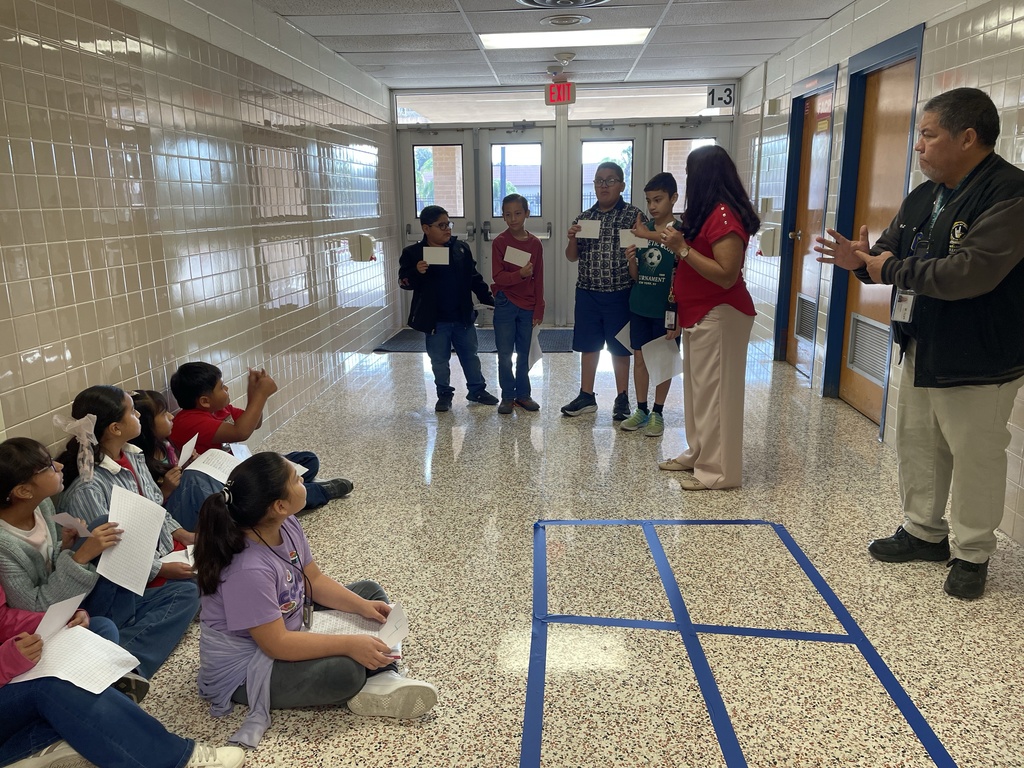 Students using total physical response to show multiplying 2 digits by 2 digits with area model