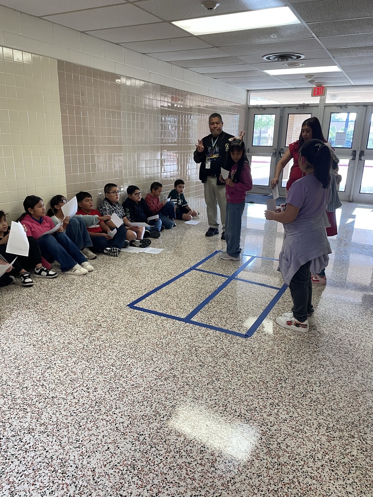 Students using total physical response to show multiplying 2 digits by 2 digits with area model
