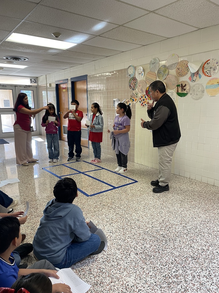 Students using total physical response to show multiplying 2 digits by 2 digits with area model