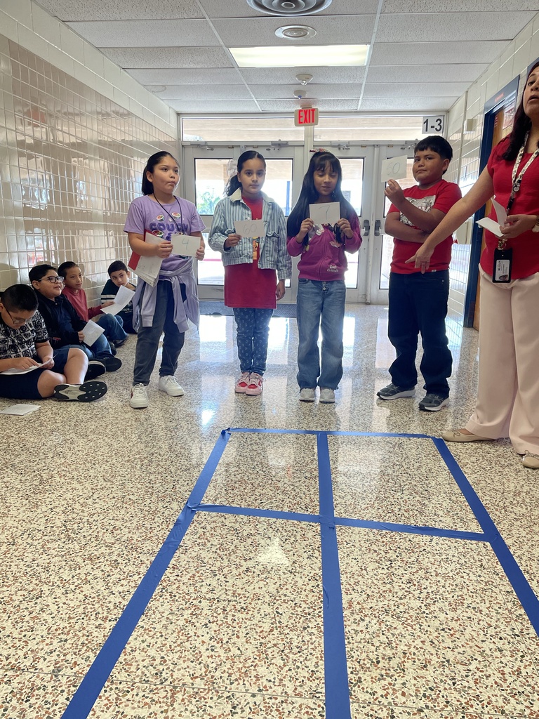 Students using total physical response to show multiplying 2 digits by 2 digits with area model