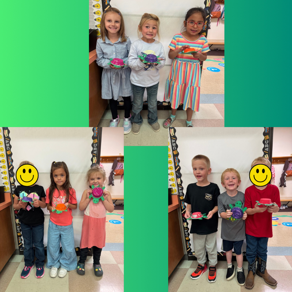 Kindergarten students showing off art projects