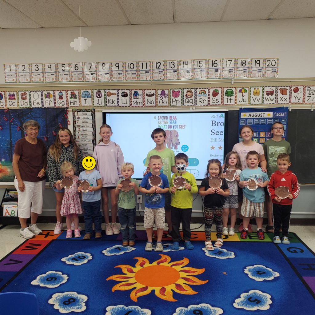 Preschoolers showing off paper plate crafts