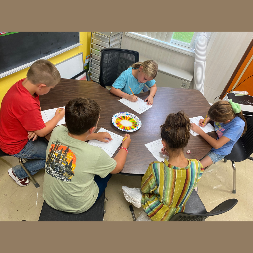 Elementary students observing the design made my Skittles candy in water