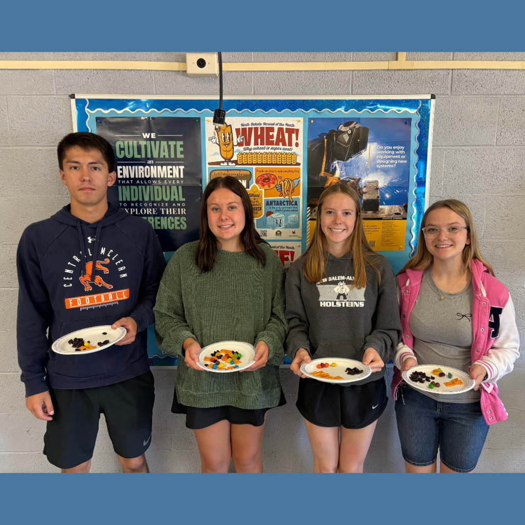 High school students posing with plates of snacks