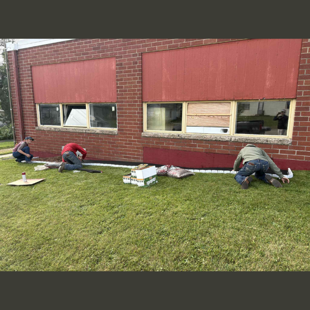 High school students landscaping in front of a school