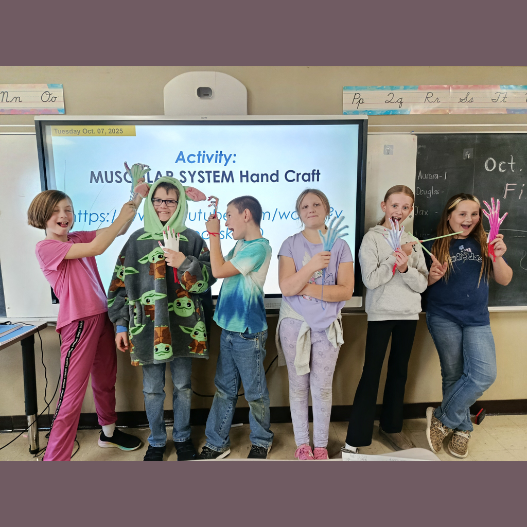 Upper elementary students showing their hand-crafted skeleton hands