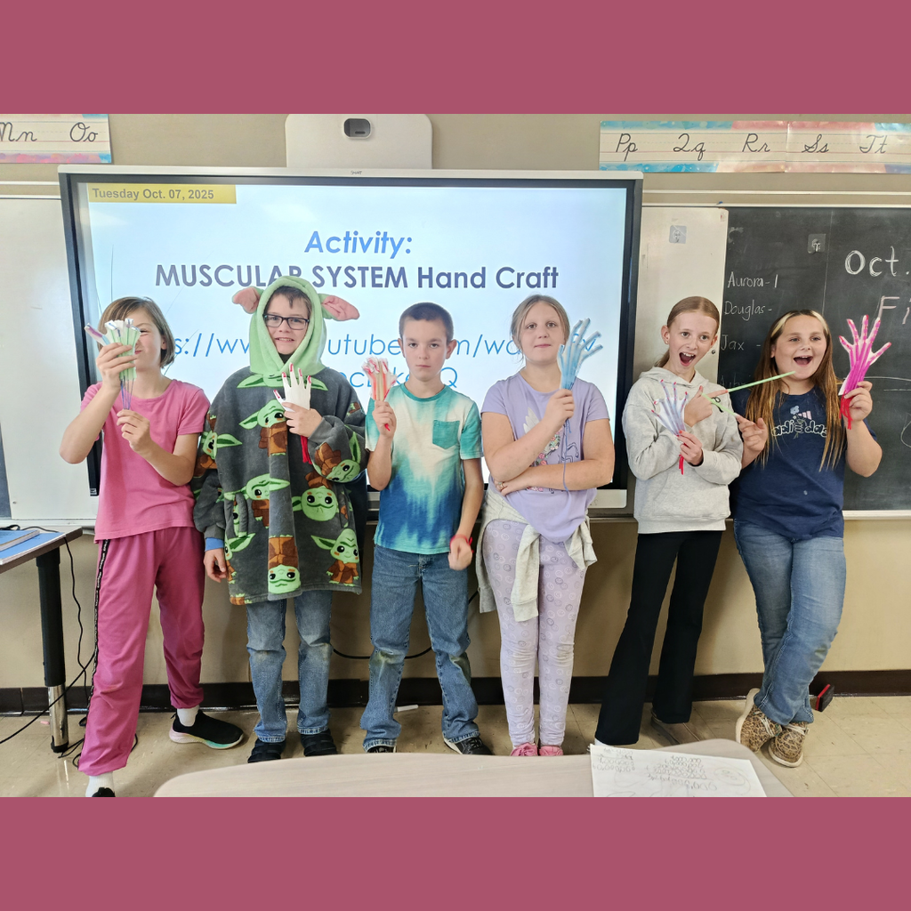 Upper elementary students showing their hand-crafted skeleton hands