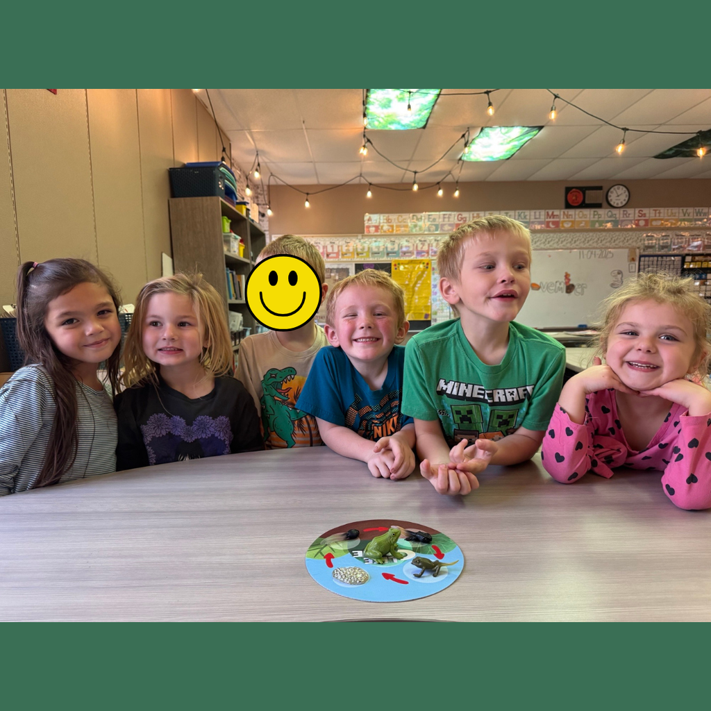 Kindergarten students posing at a table