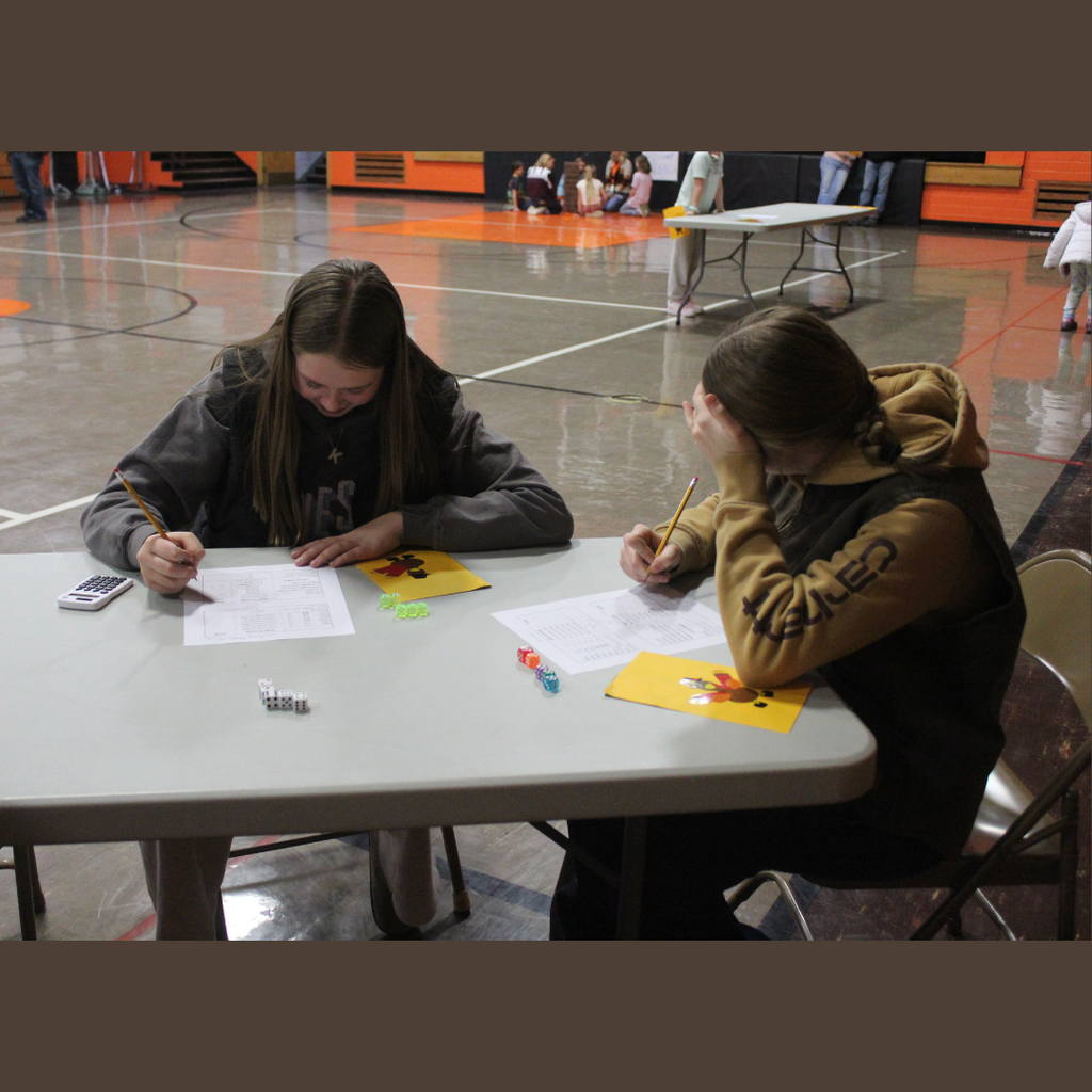 Two high school students playing Yahtzee