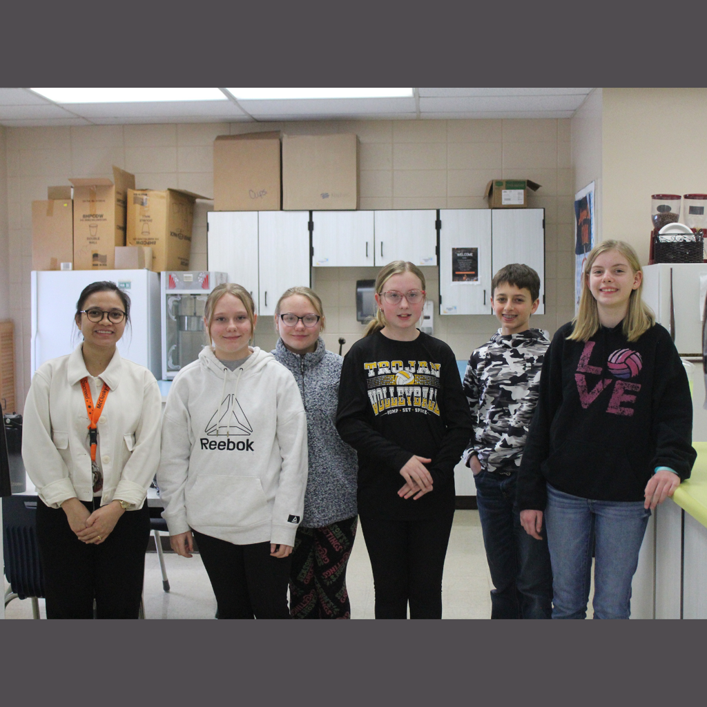 Five junior high students posing with their teacher