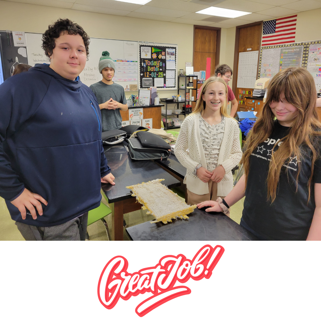 The winners of the spaghetti bridge contest posing with their bridge