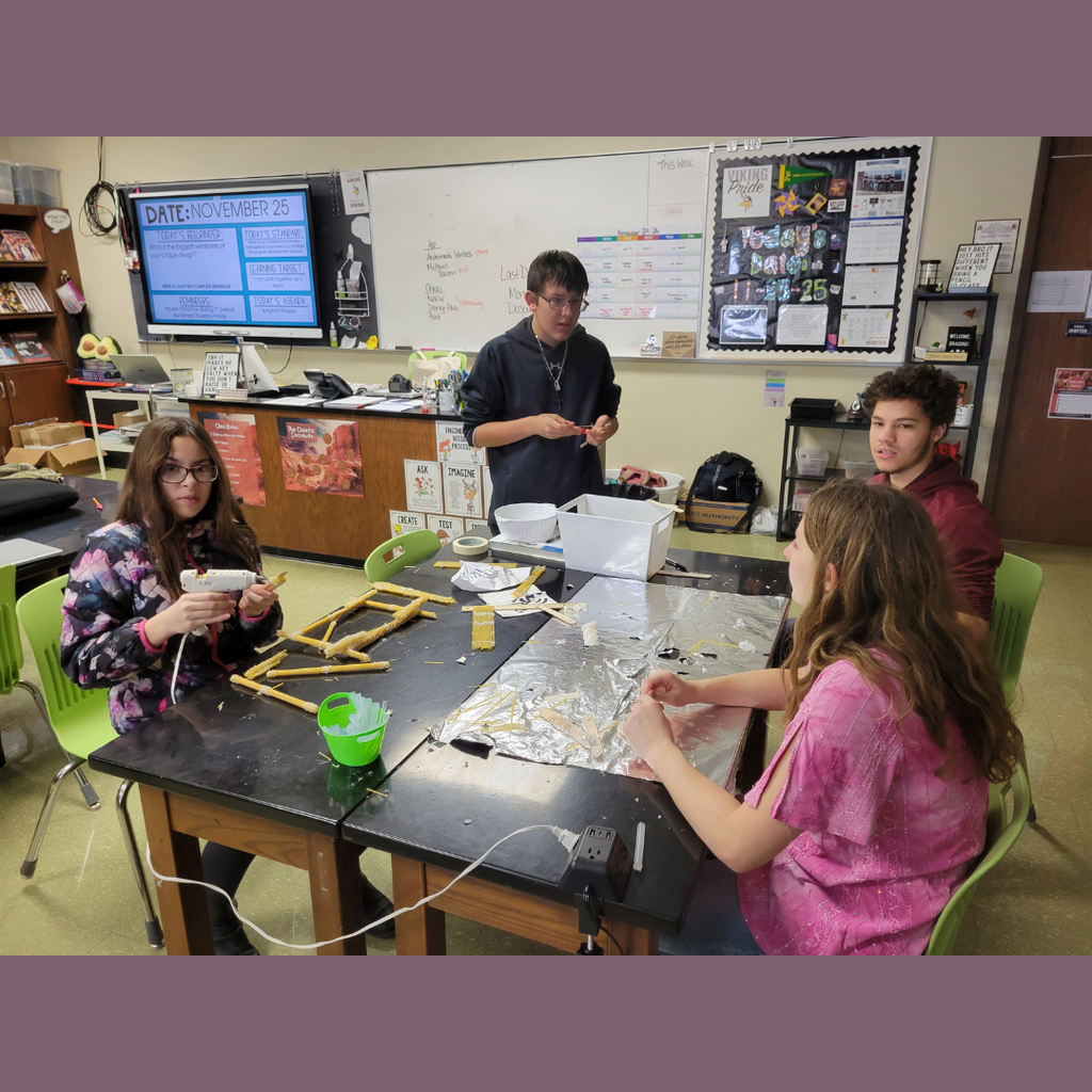 Junior high students building a bridge out of dry spaghetti noodles and hot glue