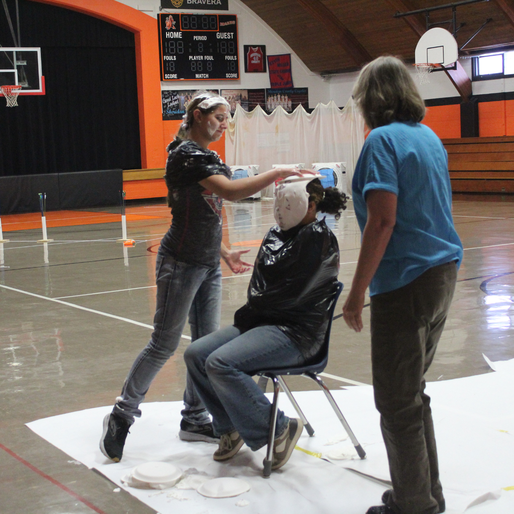 A high school student pieing another in the face