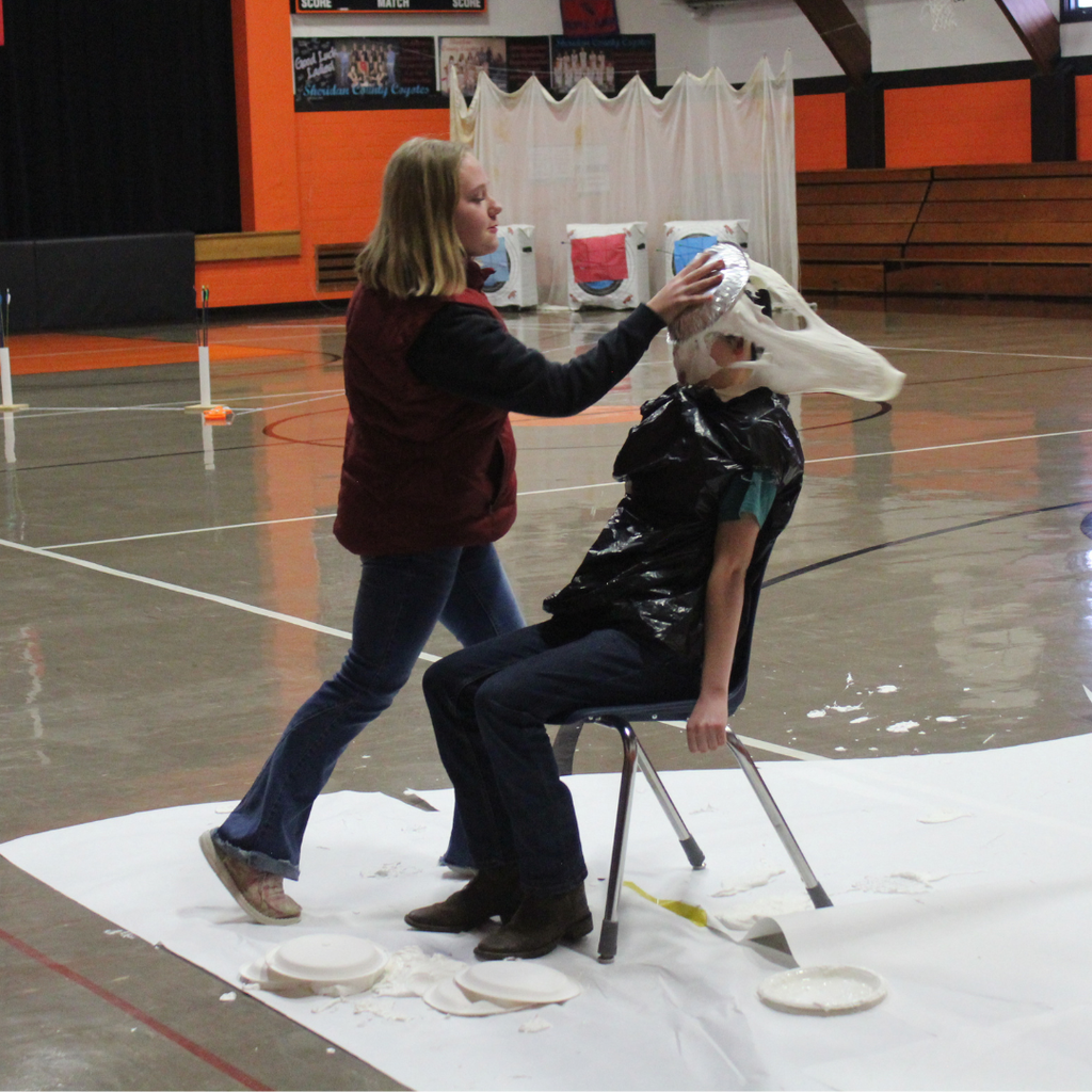 A high school student pieing another in the face