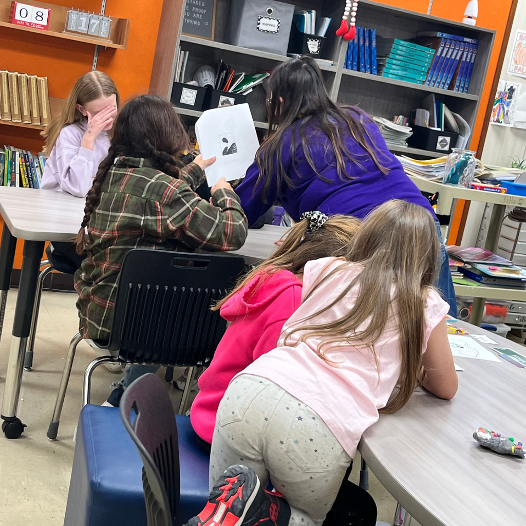 Elementary students sitting around a table