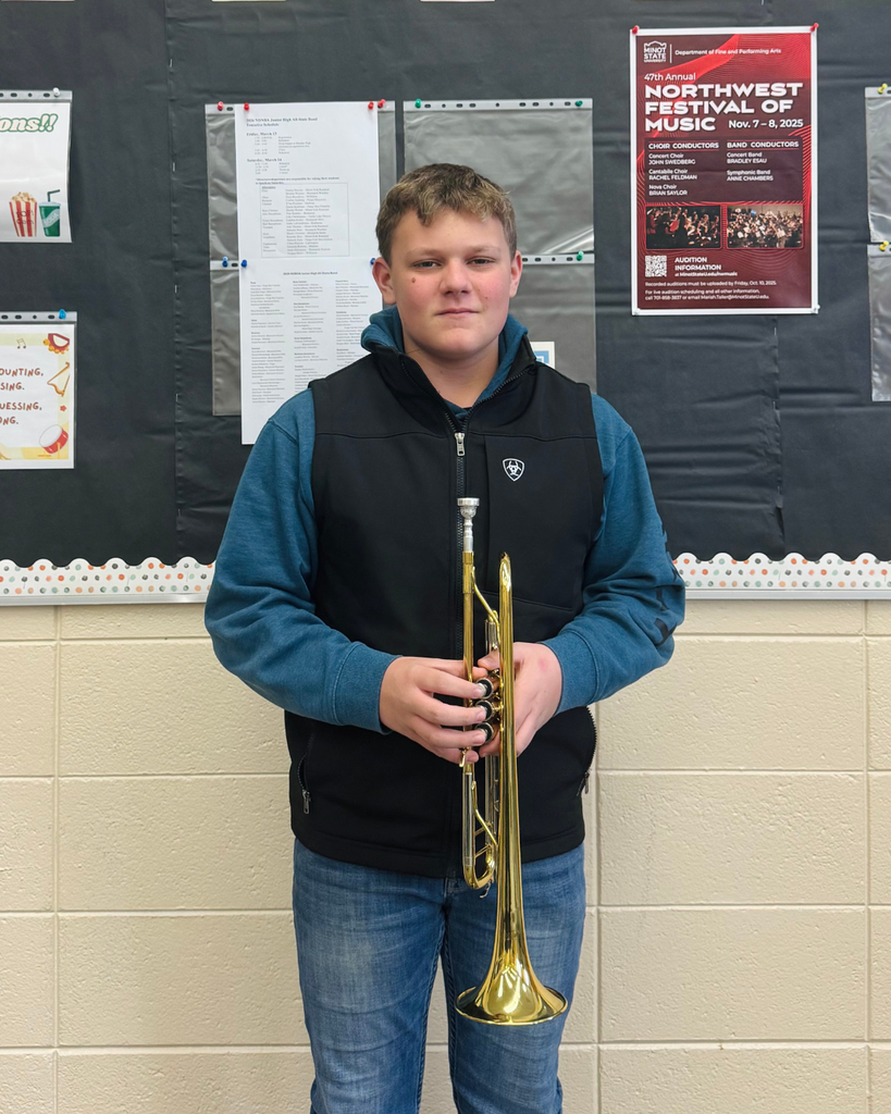 A junior high boy posing with his trumpet
