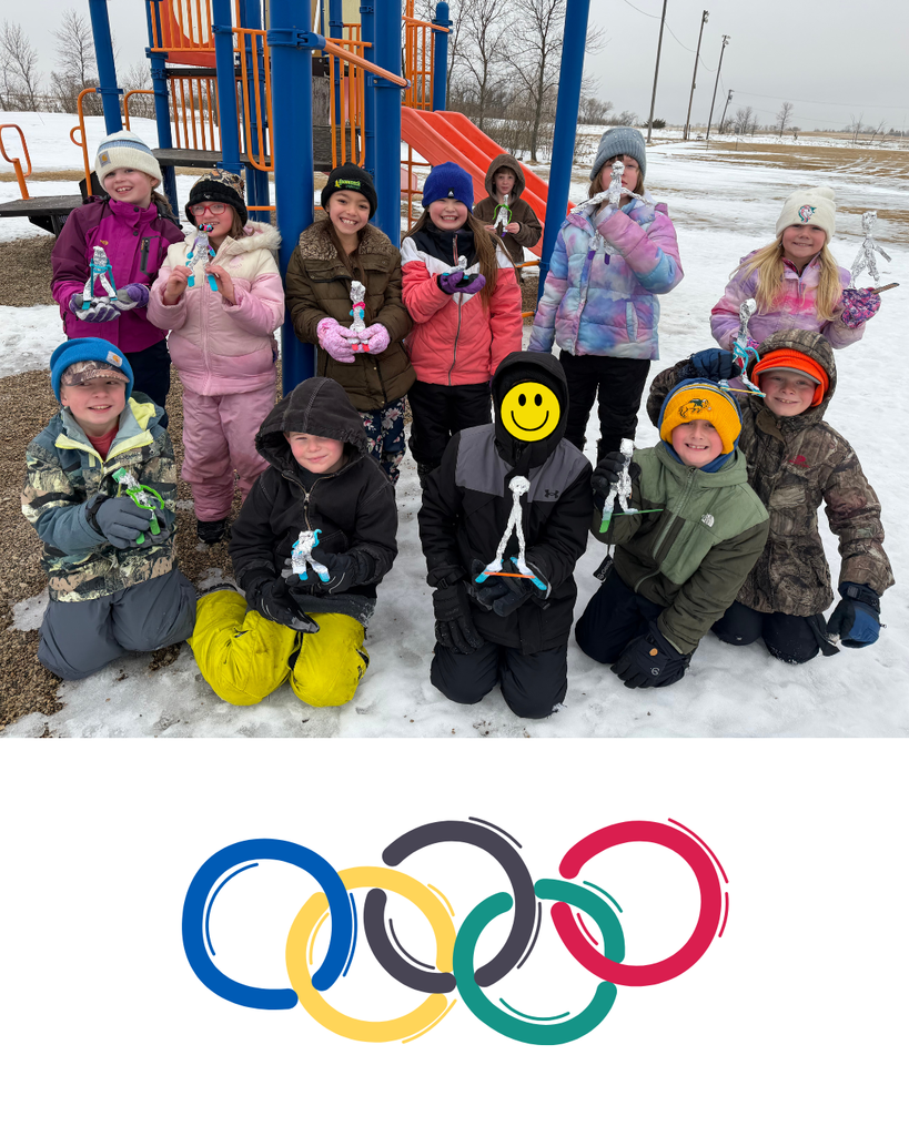 Elementary students posing with their homemade skiers outside in the snow.