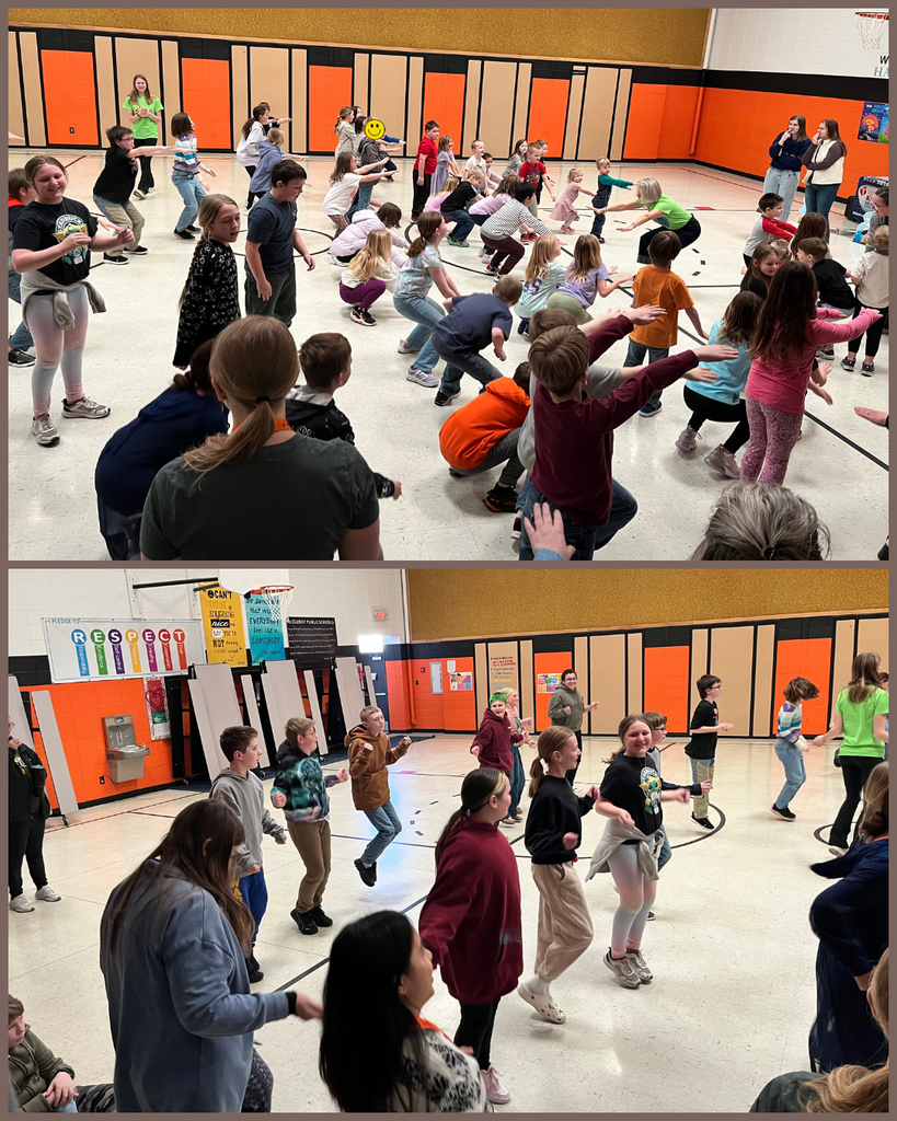 Elementary students jumping around in a school gym.