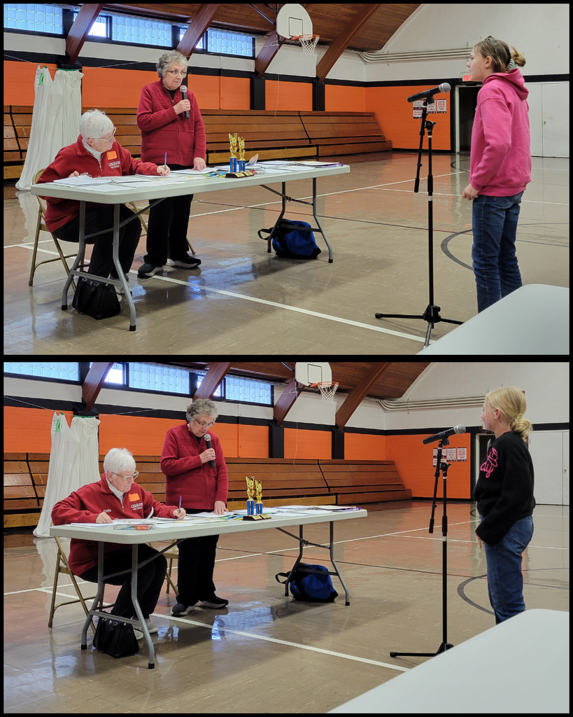 Junior high students speaking into a microphone in front of two women at a table